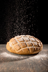 Studio shot of flour and bread drawn on black background