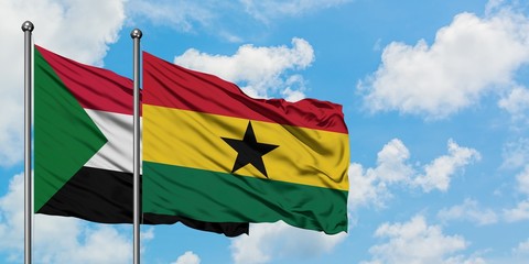 Sudan and Ghana flag waving in the wind against white cloudy blue sky together. Diplomacy concept, international relations.