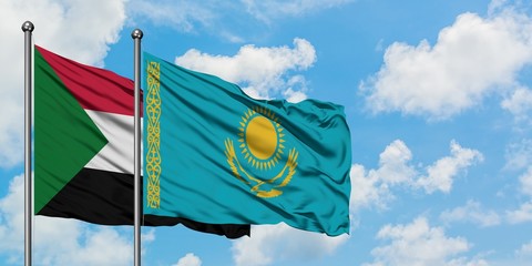 Sudan and Kazakhstan flag waving in the wind against white cloudy blue sky together. Diplomacy concept, international relations.