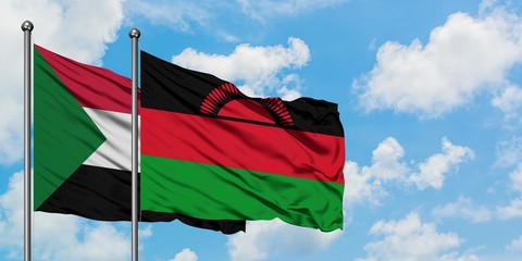 Sudan and Malawi flag waving in the wind against white cloudy blue sky together. Diplomacy concept, international relations.