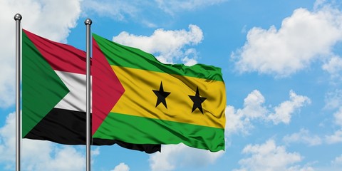 Sudan and Sao Tome And Principe flag waving in the wind against white cloudy blue sky together. Diplomacy concept, international relations.