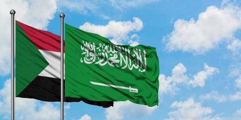 Sudan and Saudi Arabia flag waving in the wind against white cloudy blue sky together. Diplomacy concept, international relations.