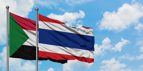 Sudan and Thailand flag waving in the wind against white cloudy blue sky together. Diplomacy concept, international relations.