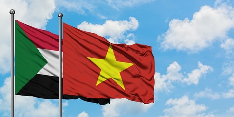 Sudan and Vietnam flag waving in the wind against white cloudy blue sky together. Diplomacy concept, international relations.