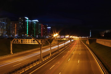 night cityscape highway with cars light trails