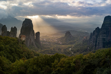 Beautiful god ray sunbeam illuminating Meteora's Roussanou convent during sunset
