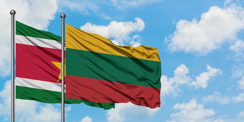 Suriname and Lithuania flag waving in the wind against white cloudy blue sky together. Diplomacy concept, international relations.