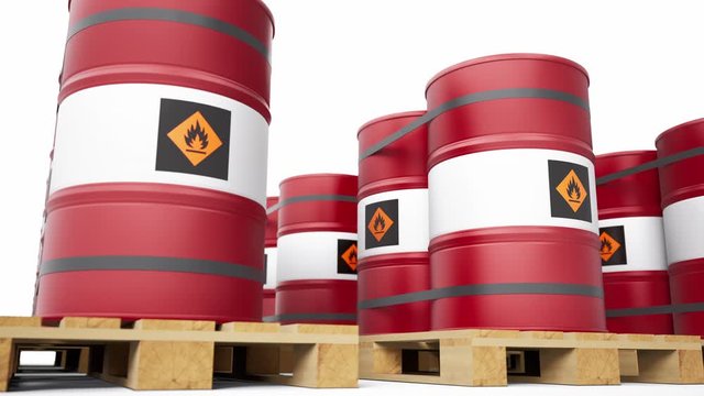 Red metal barrels with flammable symbol stacked in endless row on wooden pallets. Low angle view of palleted fuel drums. 60 fps seamless loop animation. 