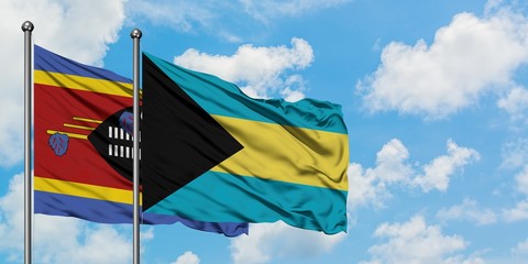 Swaziland and Bahamas flag waving in the wind against white cloudy blue sky together. Diplomacy concept, international relations.