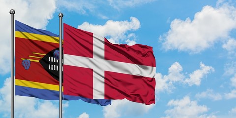 Swaziland and Denmark flag waving in the wind against white cloudy blue sky together. Diplomacy concept, international relations.