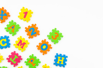 Colorful kids puzzle toys on white background. Mockup with space for your text