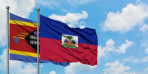 Swaziland and Haiti flag waving in the wind against white cloudy blue sky together. Diplomacy concept, international relations.