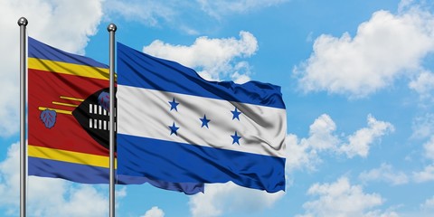 Swaziland and Honduras flag waving in the wind against white cloudy blue sky together. Diplomacy concept, international relations.