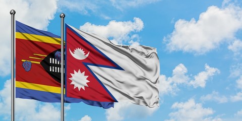 Swaziland and Nepal flag waving in the wind against white cloudy blue sky together. Diplomacy concept, international relations.