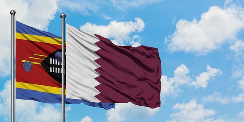 Swaziland and Qatar flag waving in the wind against white cloudy blue sky together. Diplomacy concept, international relations.