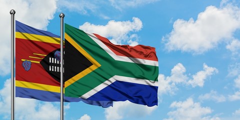 Swaziland and South Africa flag waving in the wind against white cloudy blue sky together. Diplomacy concept, international relations.