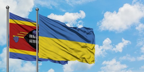 Swaziland and Ukraine flag waving in the wind against white cloudy blue sky together. Diplomacy concept, international relations.