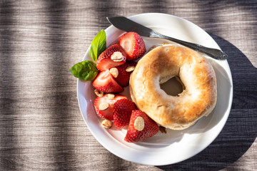 Holiday Themed Breakfast of Bagel and Strawberries on Wooden Table
