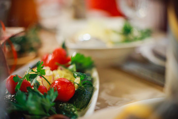 Plate with pickles - salty, saline tomatoes, pickles, corned onions and garnished with parsley. Cold appetizers in the restaurant at banquet in honor of holiday. New Year's table in Ukraine.