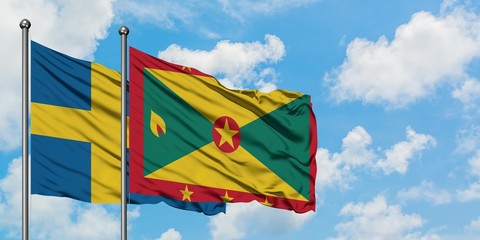 Sweden and Grenada flag waving in the wind against white cloudy blue sky together. Diplomacy concept, international relations.