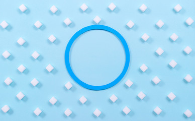 Symbol of diabestes with sugar cube on pastel blue background. World diabestes day concept.