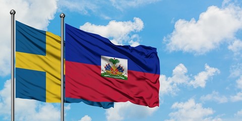 Sweden and Haiti flag waving in the wind against white cloudy blue sky together. Diplomacy concept, international relations.