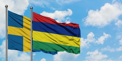 Sweden and Mauritius flag waving in the wind against white cloudy blue sky together. Diplomacy concept, international relations.