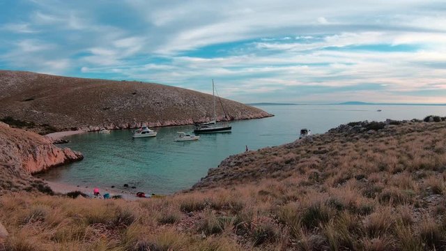 Panorama of the gulf on island Grgur. Summer in Croatia. Sunset. Lots of small anchored boats , prepared for a stay over the night.