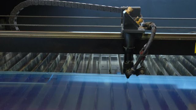 Laser cutting machine carving patterns on the plastic plate
