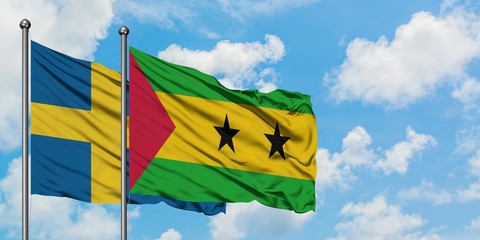 Sweden and Sao Tome And Principe flag waving in the wind against white cloudy blue sky together. Diplomacy concept, international relations.
