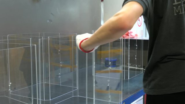 Worker sorting plastic parts and collect order