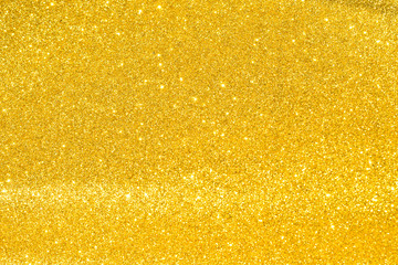sparkles of golden glitter texture background	