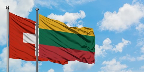Switzerland and Lithuania flag waving in the wind against white cloudy blue sky together. Diplomacy concept, international relations.