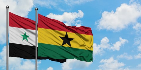 Syria and Ghana flag waving in the wind against white cloudy blue sky together. Diplomacy concept, international relations.