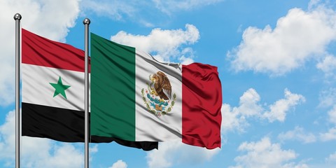 Syria and Mexico flag waving in the wind against white cloudy blue sky together. Diplomacy concept,...