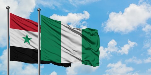 Syria and Nigeria flag waving in the wind against white cloudy blue sky together. Diplomacy...