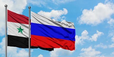 Syria and Russia flag waving in the wind against white cloudy blue sky together. Diplomacy concept,...
