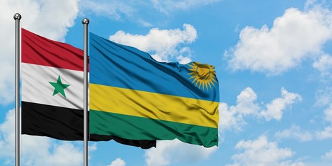 Syria and Rwanda flag waving in the wind against white cloudy blue sky together. Diplomacy concept, international relations.