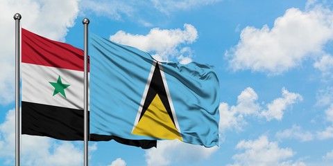 Syria and Saint Lucia flag waving in the wind against white cloudy blue sky together. Diplomacy...