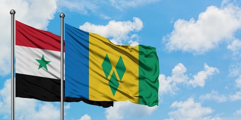 Syria and Saint Vincent And The Grenadines flag waving in the wind against white cloudy blue sky...
