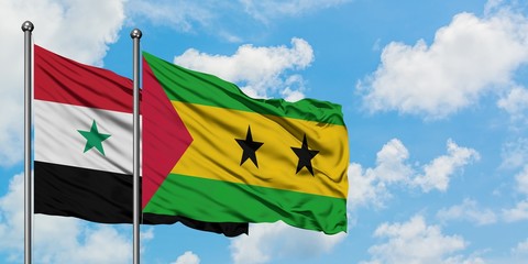 Syria and Sao Tome And Principe flag waving in the wind against white cloudy blue sky together. Diplomacy concept, international relations.