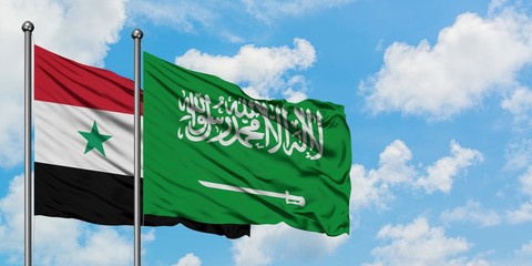 Syria and Saudi Arabia flag waving in the wind against white cloudy blue sky together. Diplomacy concept, international relations.