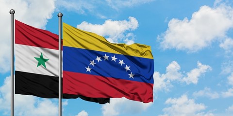 Syria and Venezuela flag waving in the wind against white cloudy blue sky together. Diplomacy concept, international relations.