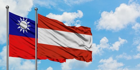 Taiwan and Austria flag waving in the wind against white cloudy blue sky together. Diplomacy concept, international relations.