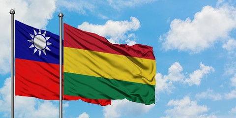 Taiwan and Bolivia flag waving in the wind against white cloudy blue sky together. Diplomacy concept, international relations.