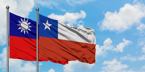 Taiwan and Chile flag waving in the wind against white cloudy blue sky together. Diplomacy concept, international relations.