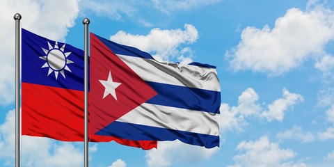 Taiwan and Cuba flag waving in the wind against white cloudy blue sky together. Diplomacy concept, international relations.