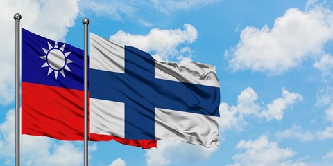 Taiwan and Finland flag waving in the wind against white cloudy blue sky together. Diplomacy concept, international relations.