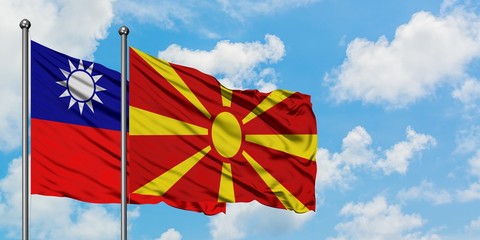 Taiwan and Macedonia flag waving in the wind against white cloudy blue sky together. Diplomacy concept, international relations.