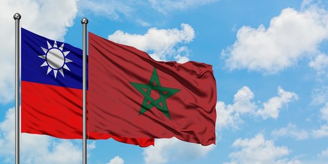 Taiwan and Morocco flag waving in the wind against white cloudy blue sky together. Diplomacy concept, international relations.